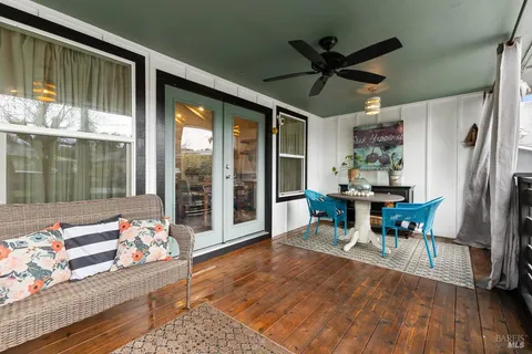 a dining room with furniture window and wooden floor