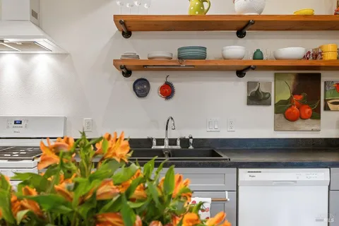 a close view of sink and wooden cabinets