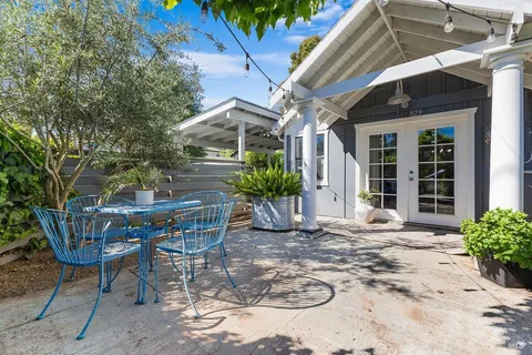 a view of a patio with table and chairs and potted plants