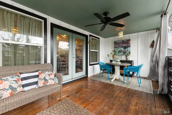 a dining room with furniture window and wooden floor