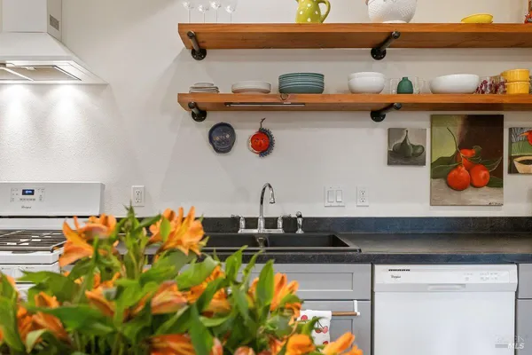 a close view of sink and wooden cabinets