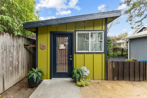 a front view of a house with a garden