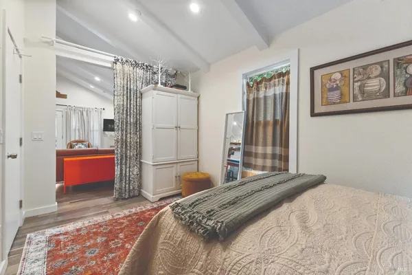 a bedroom with a large bed a chandelier and closet