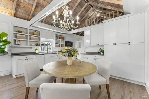 a dining room with furniture and chandelier