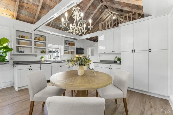 a dining room with furniture and chandelier
