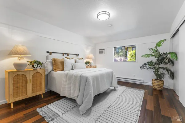 a spacious bedroom with bed and a window