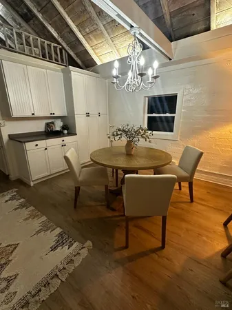 a dining room with furniture and a chandelier