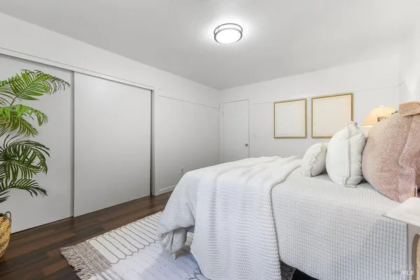 a bedroom with a bed and a potted plant