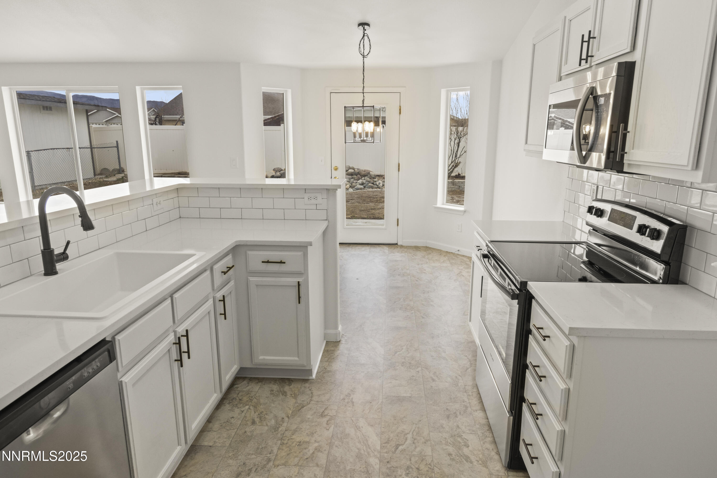 1418 Red Bluffs Way Fernley, NV 89408 - Photo 11 of 35 a kitchen that has a sink a stove and cabinets