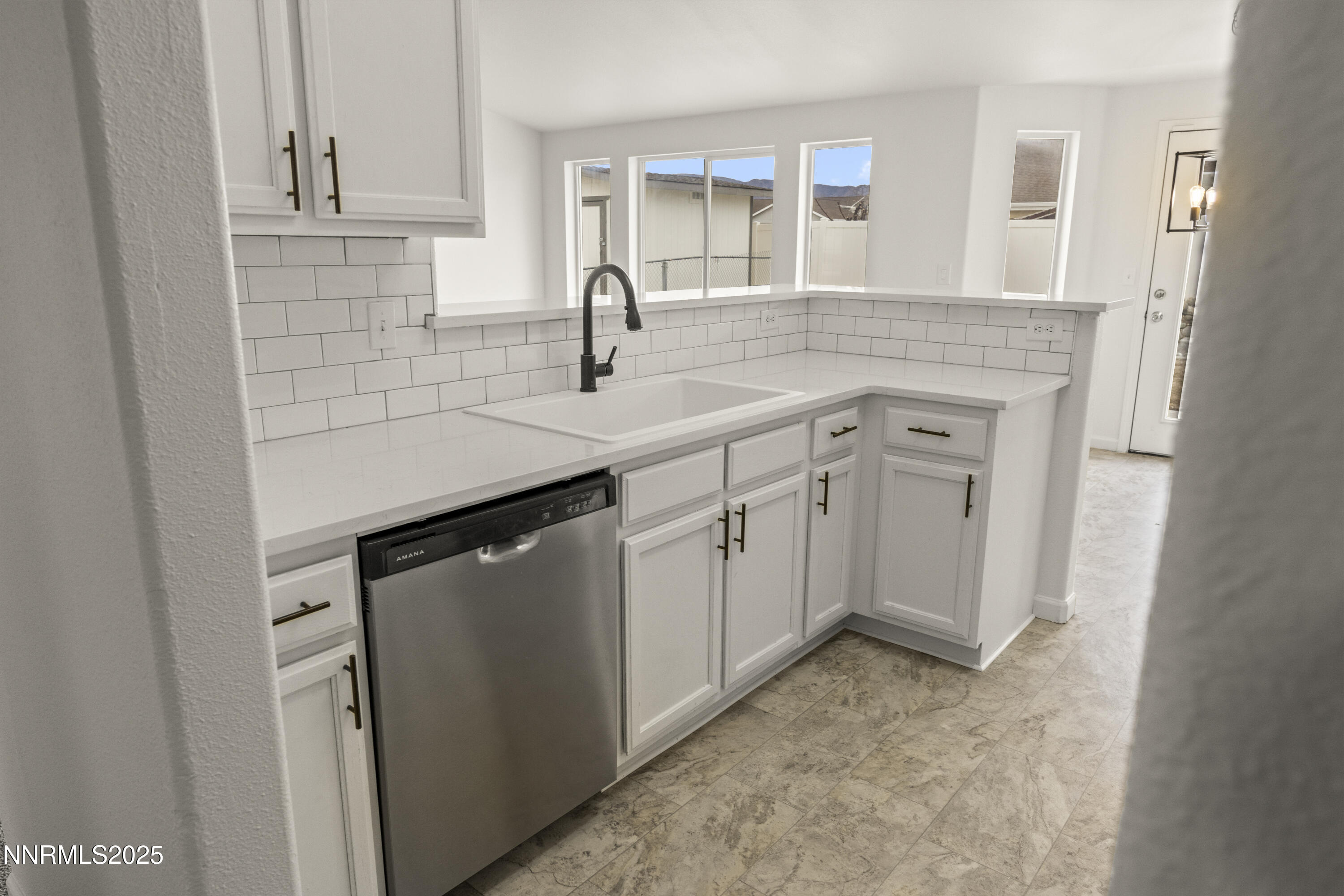 1418 Red Bluffs Way Fernley, NV 89408 - Photo 13 of 35 a kitchen with white cabinets and sink