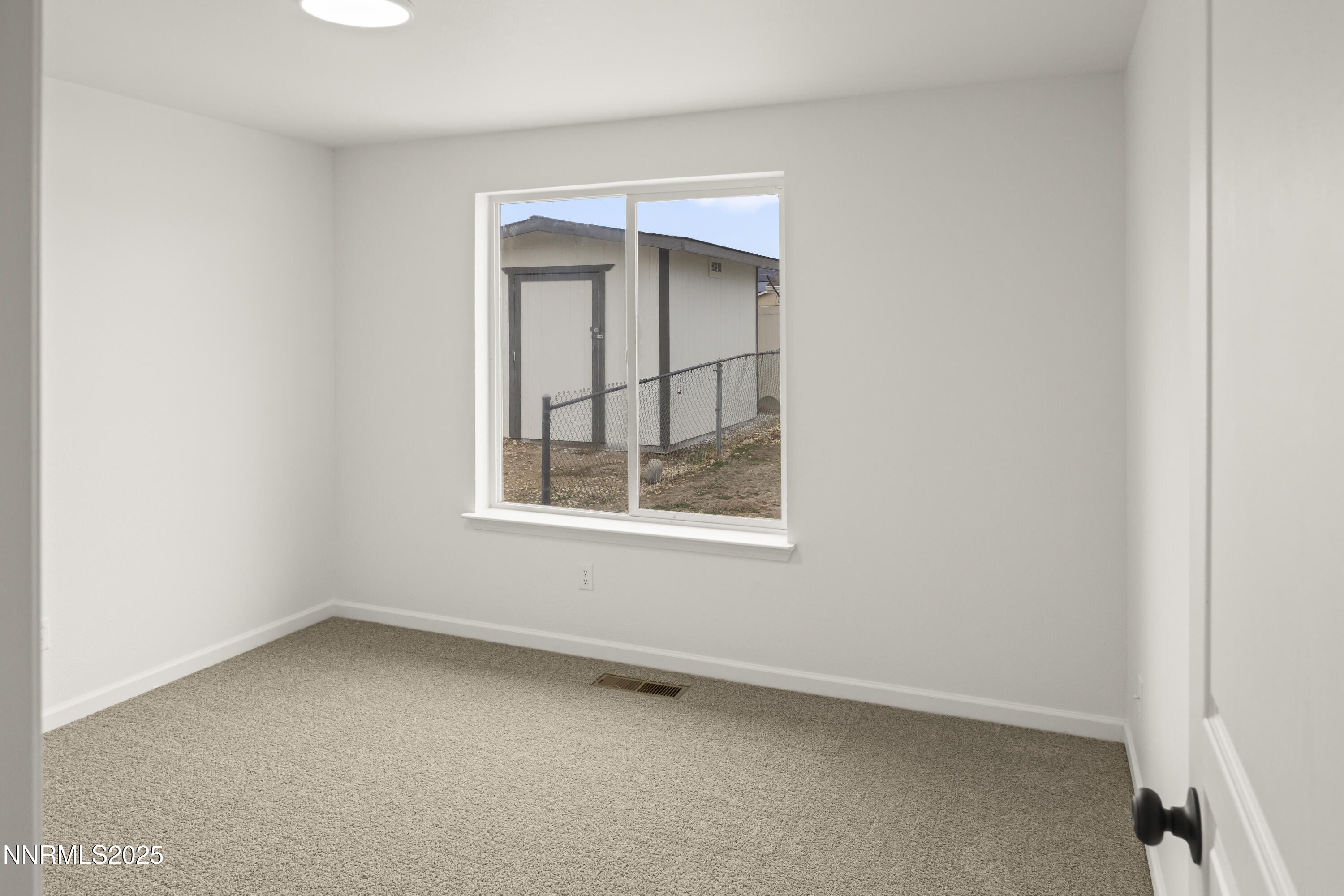 1418 Red Bluffs Way Fernley, NV 89408 - Photo 16 of 35 an empty room with a window