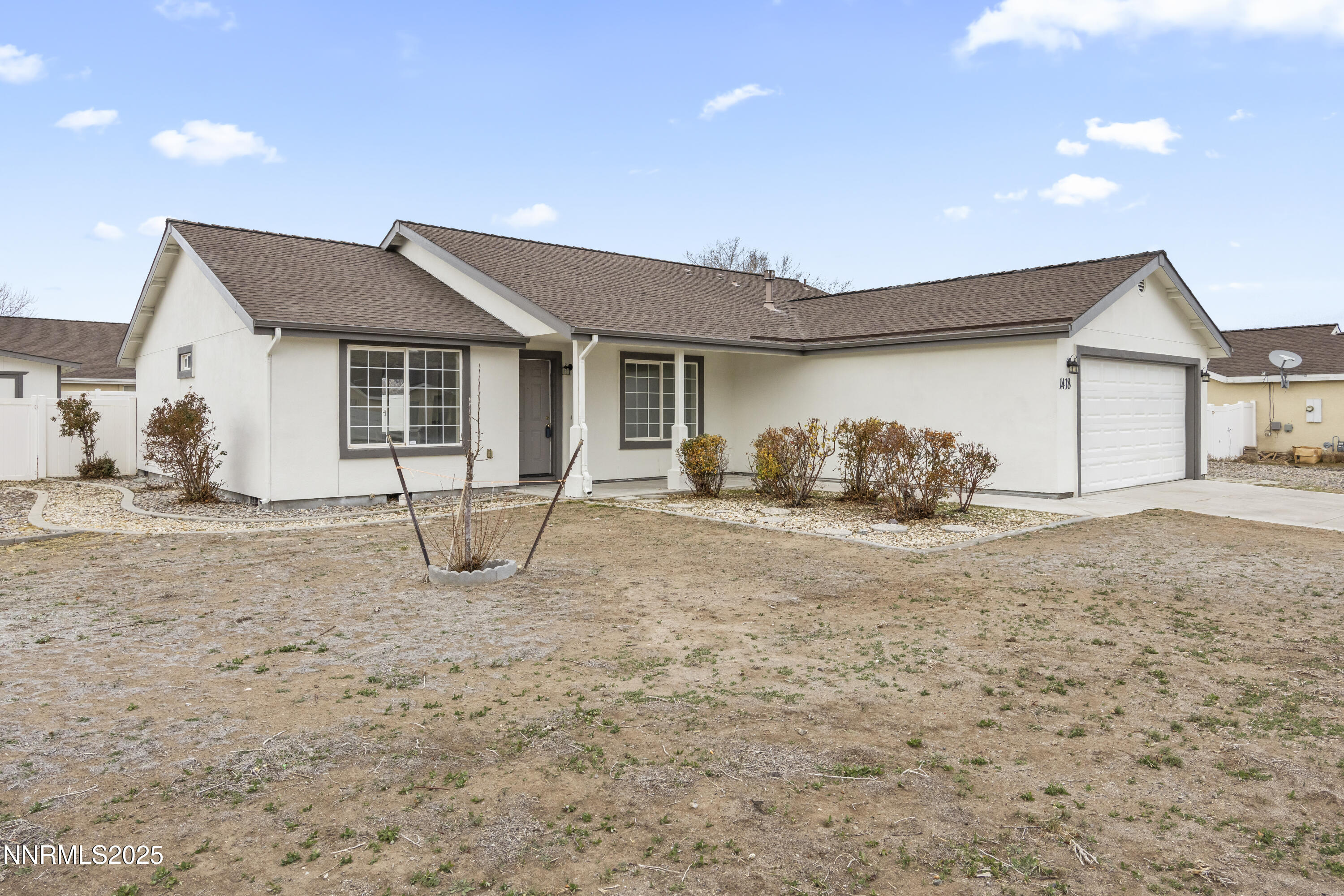 1418 Red Bluffs Way Fernley, NV 89408 - Photo 2 of 35 a view of a house with a yard