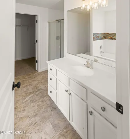 a white bath tub sitting next to a white toilet