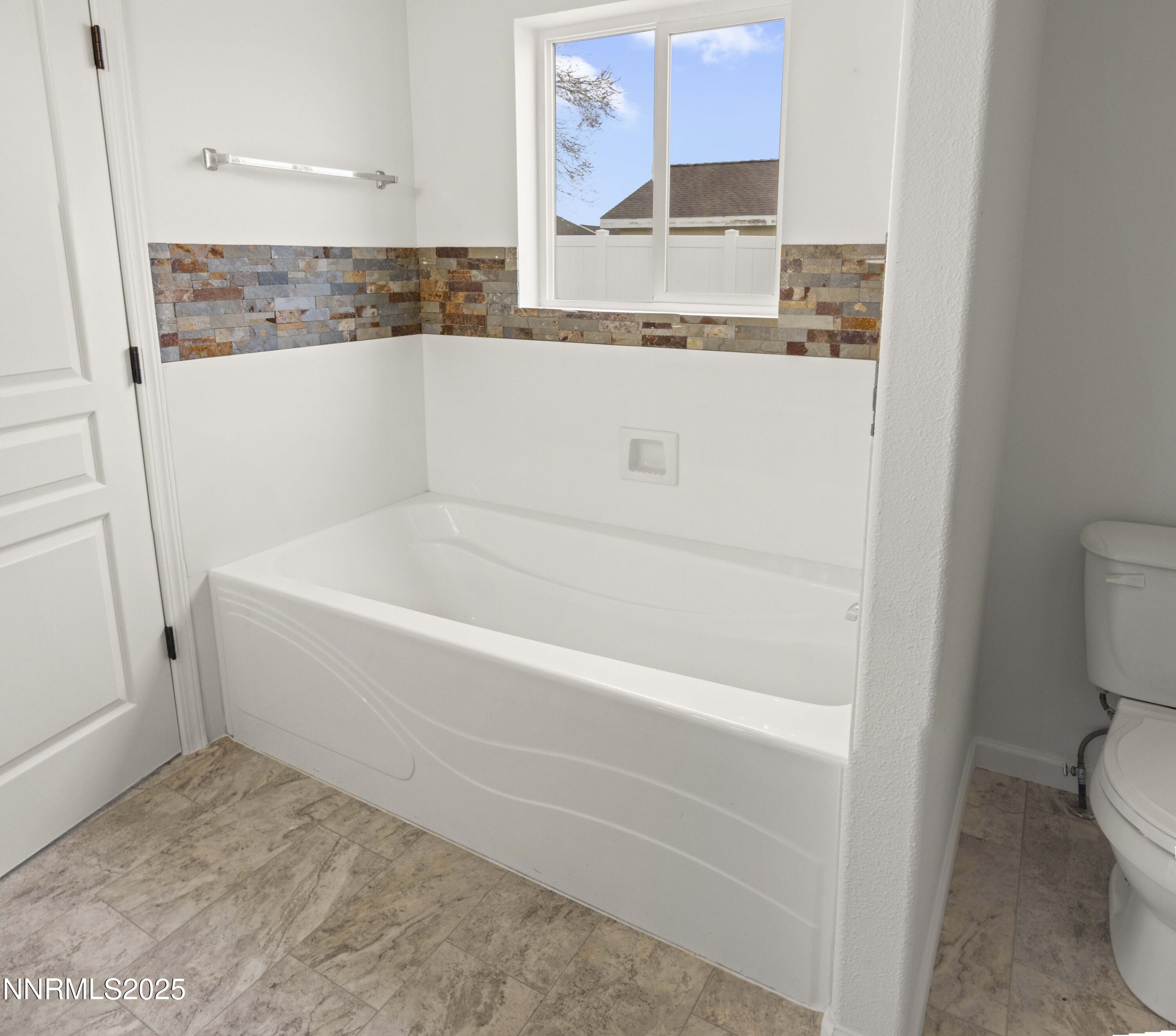 1418 Red Bluffs Way Fernley, NV 89408 - Photo 22 of 35 a white bath tub sitting next to a white toilet