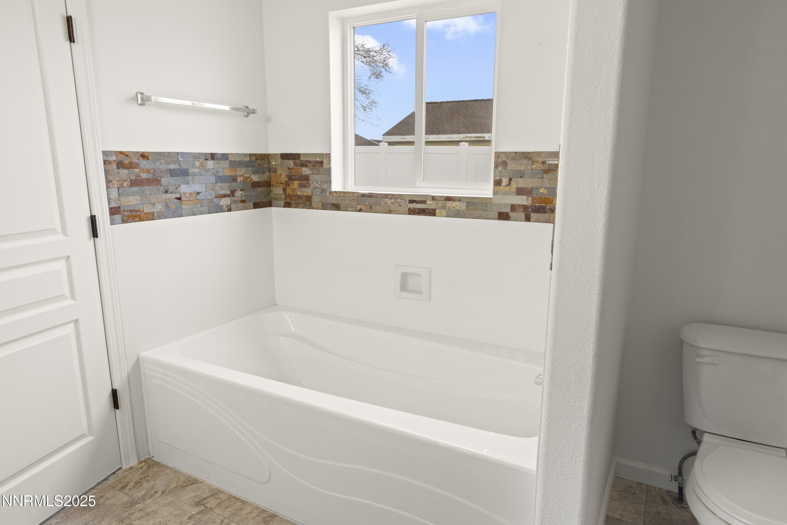 1418 Red Bluffs Way Fernley, NV 89408 - Photo 23 of 35 a white bath tub sitting next to a white toilet