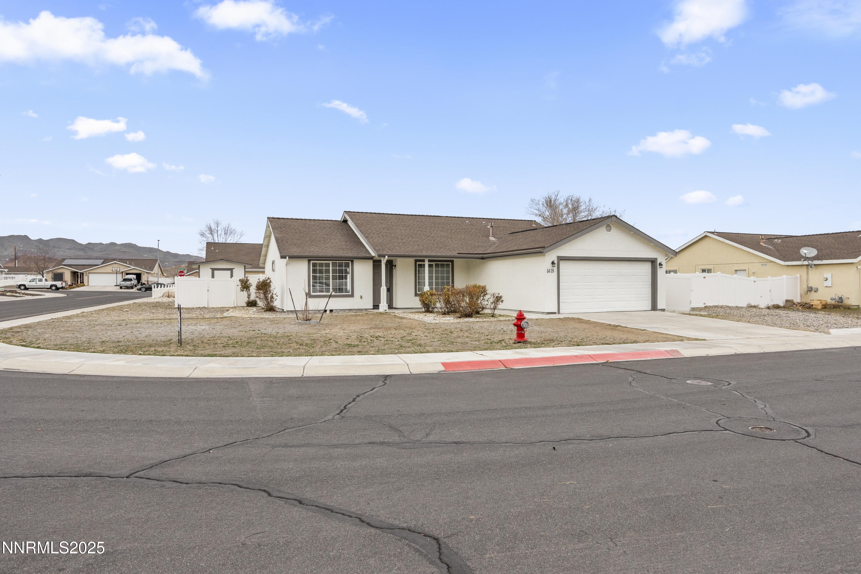 1418 Red Bluffs Way Fernley, NV 89408 - Photo 25 of 35 a front view of a house with a road