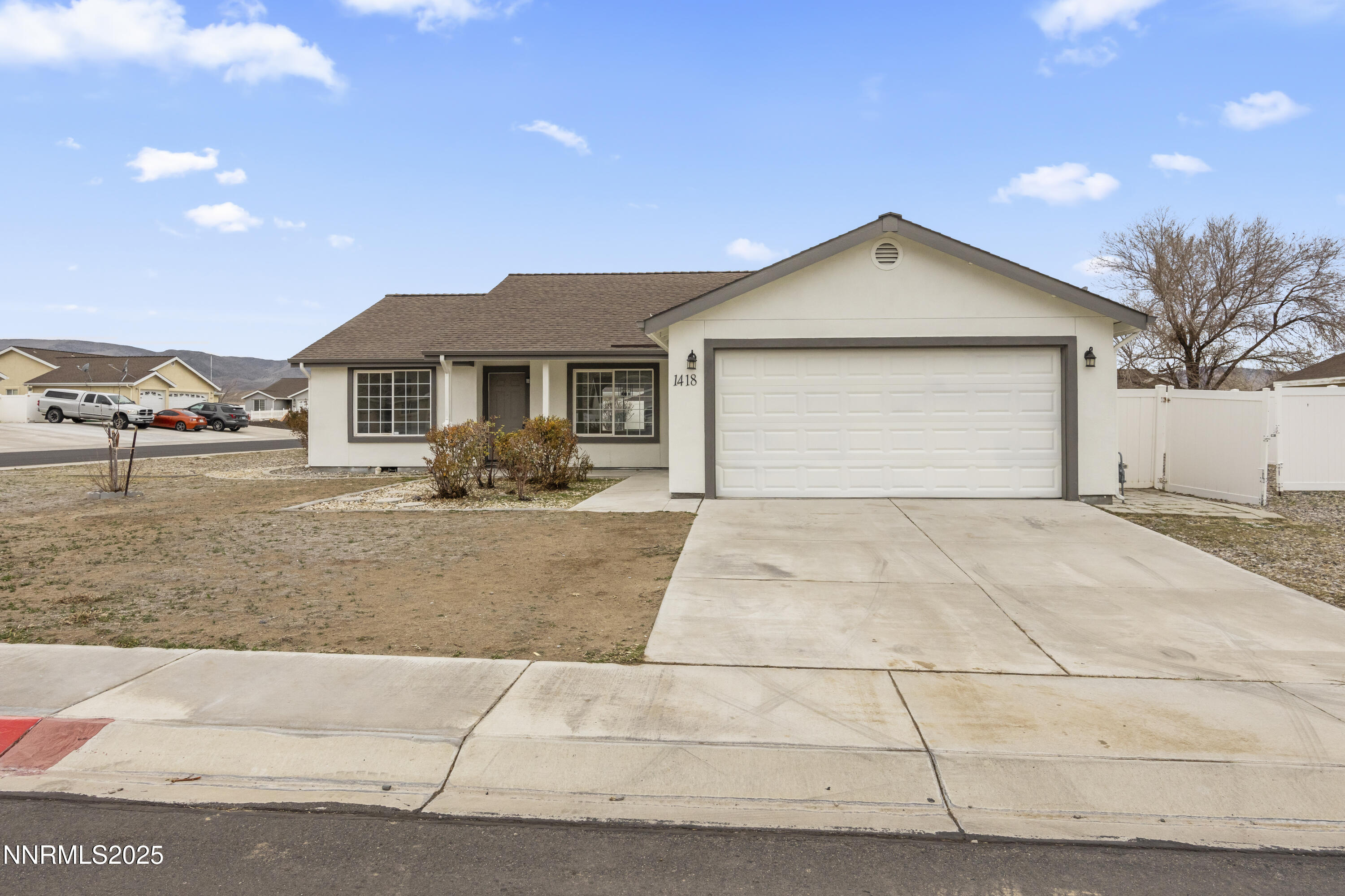 1418 Red Bluffs Way Fernley, NV 89408 - Photo 3 of 35 a front view of a house with natural light