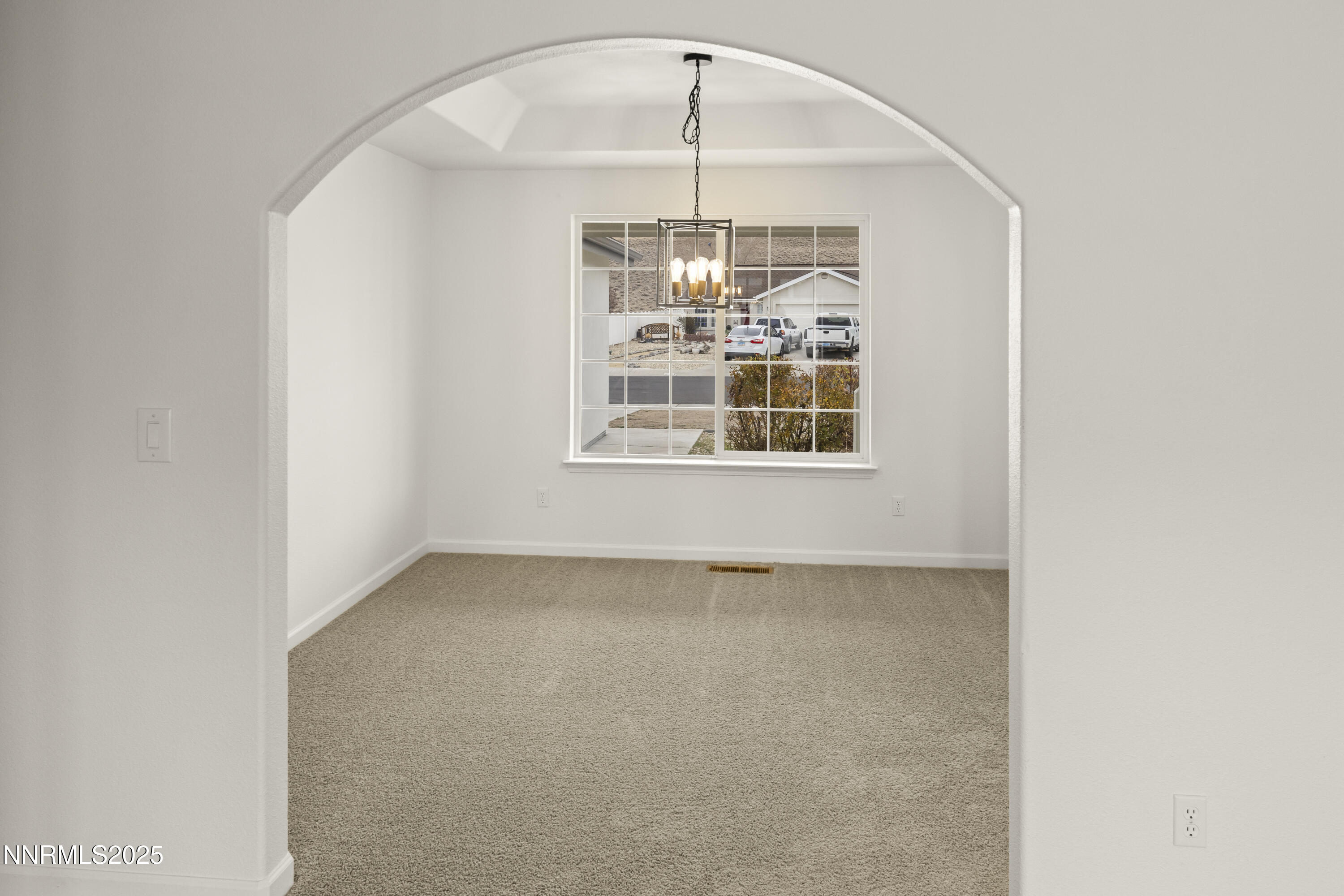 1418 Red Bluffs Way Fernley, NV 89408 - Photo 7 of 35 an empty room with a window