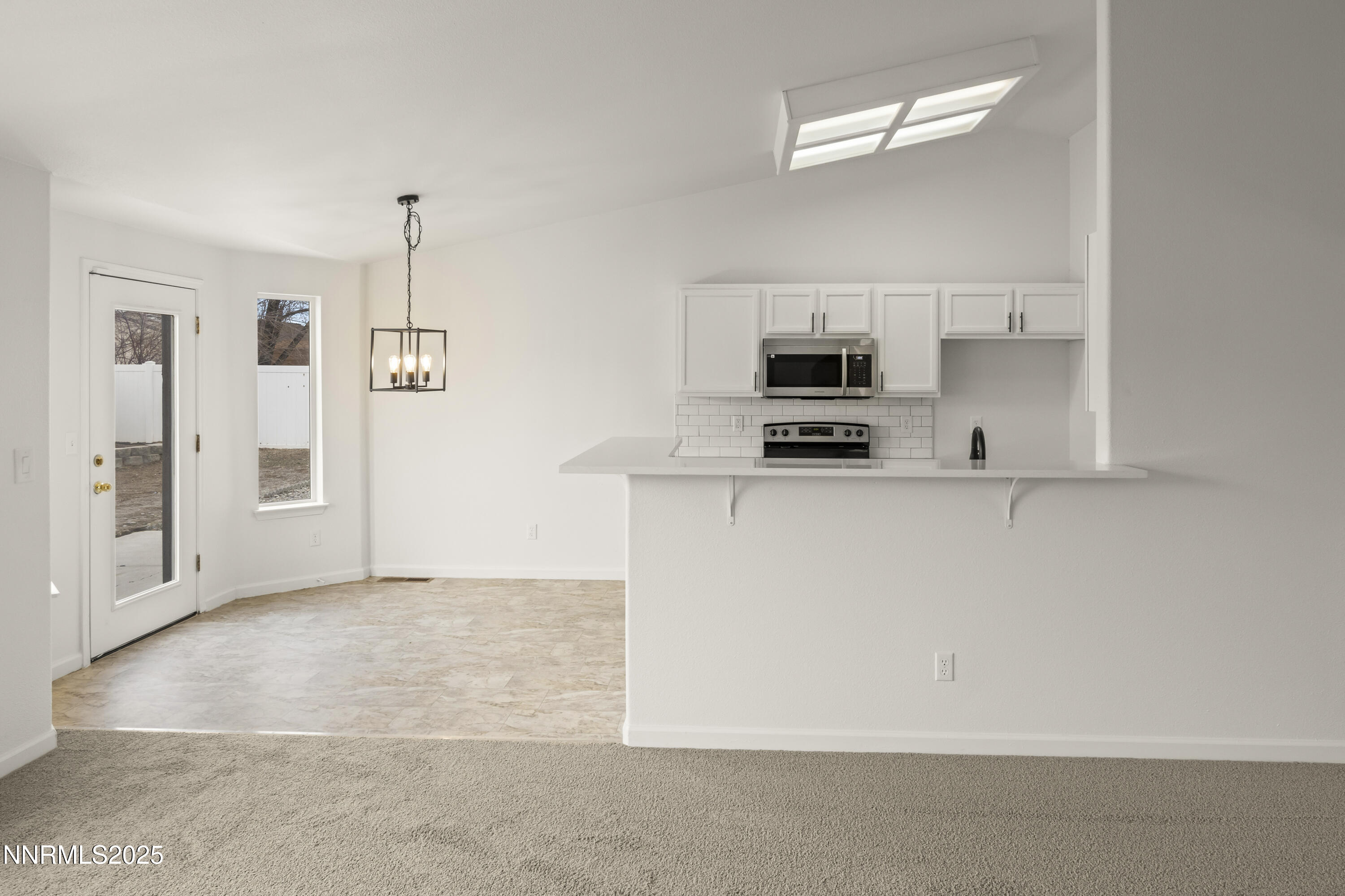 1418 Red Bluffs Way Fernley, NV 89408 - Photo 8 of 35 a kitchen with granite countertop a refrigerator a stove a microwave and a sink