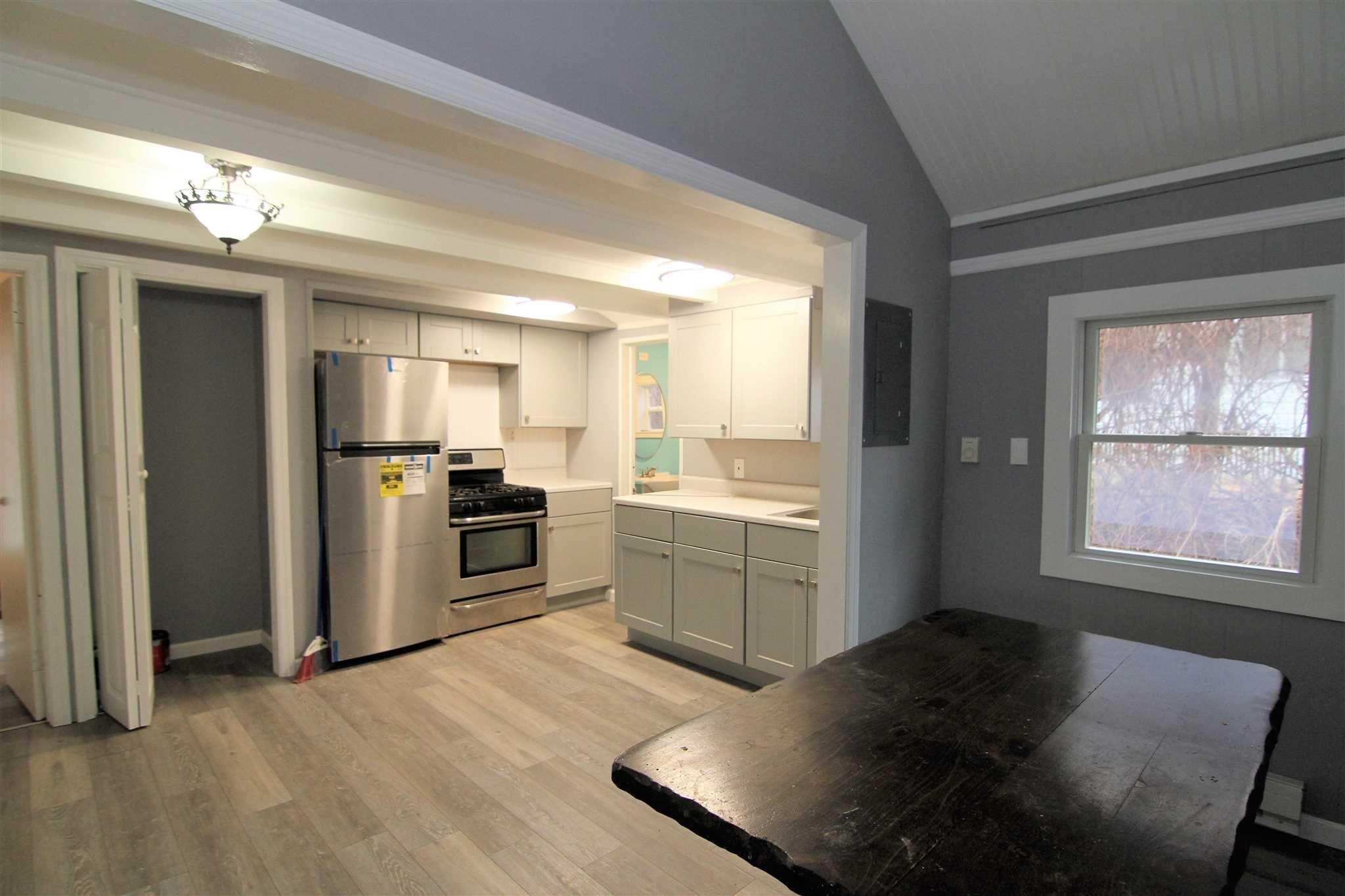 a kitchen with a refrigerator and a stove top oven