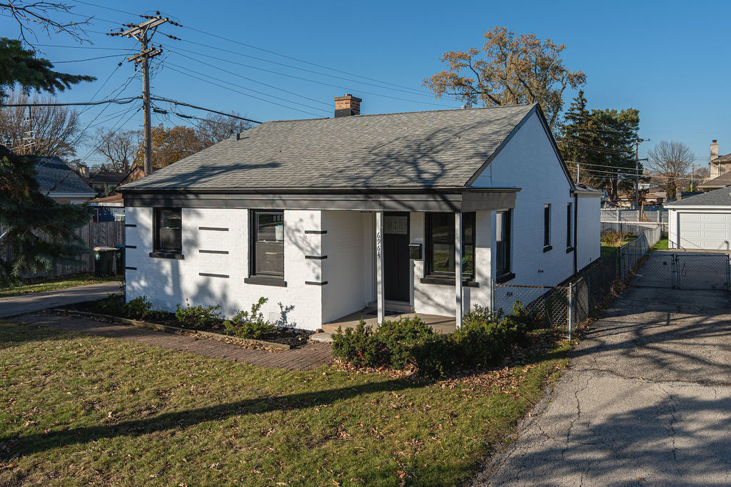 6964 West Cleveland Street Niles, IL 60714 - Photo 16 of 18 a front view of a house with garden