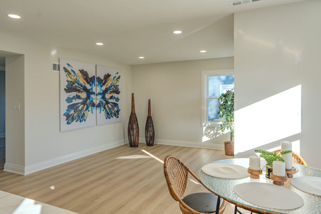 6964 West Cleveland Street Niles, IL 60714 - Photo 4 of 18 a view of a dining room with furniture and wooden floor