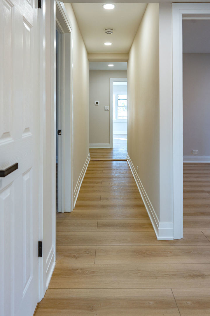 6964 West Cleveland Street Niles, IL 60714 - Photo 6 of 18 a view of a hallway with wooden floor and staircase