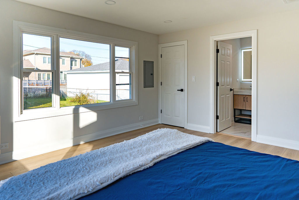 6964 West Cleveland Street Niles, IL 60714 - Photo 8 of 18 an empty room with wooden floor and windows