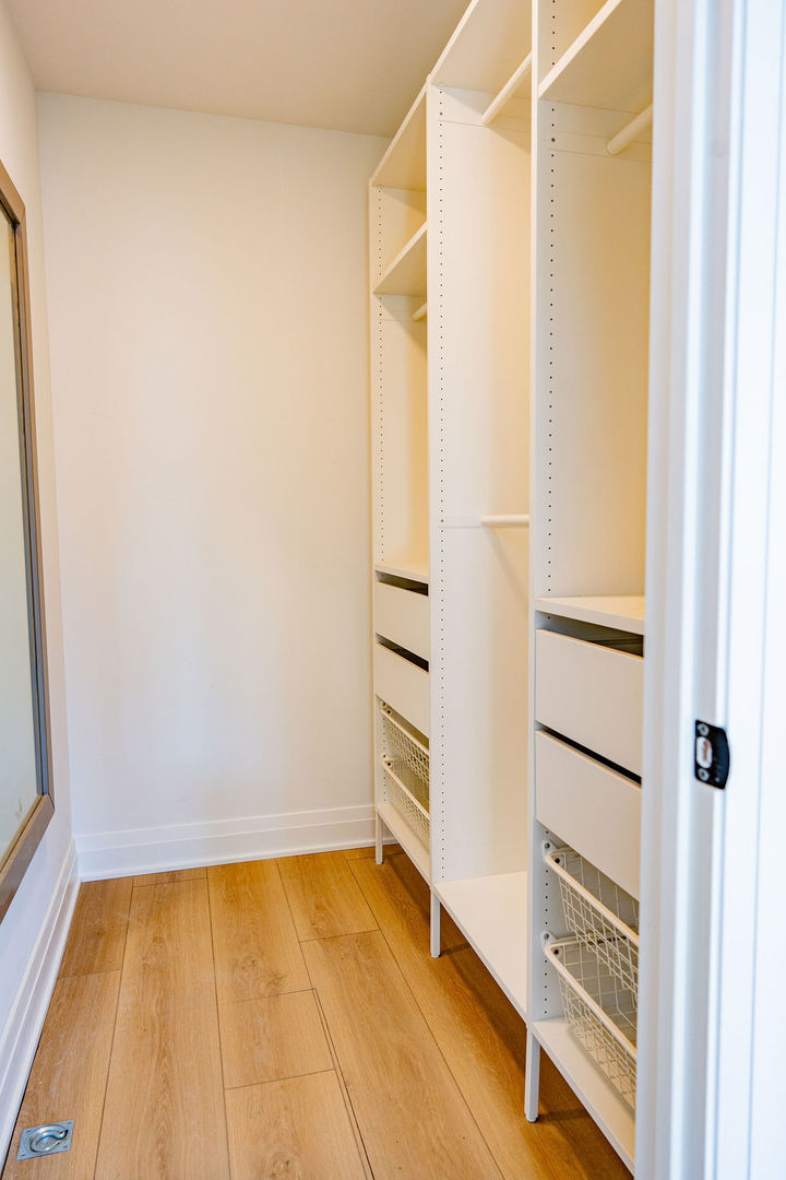 6964 West Cleveland Street Niles, IL 60714 - Photo 9 of 18 a view of an empty room with a window and wooden floor