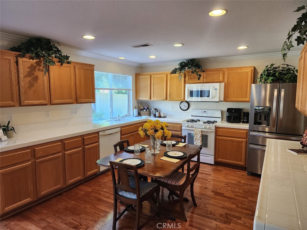 9 Calais Irvine, CA 92602 - Photo 5 of 21 a kitchen with a table chairs refrigerator and microwave