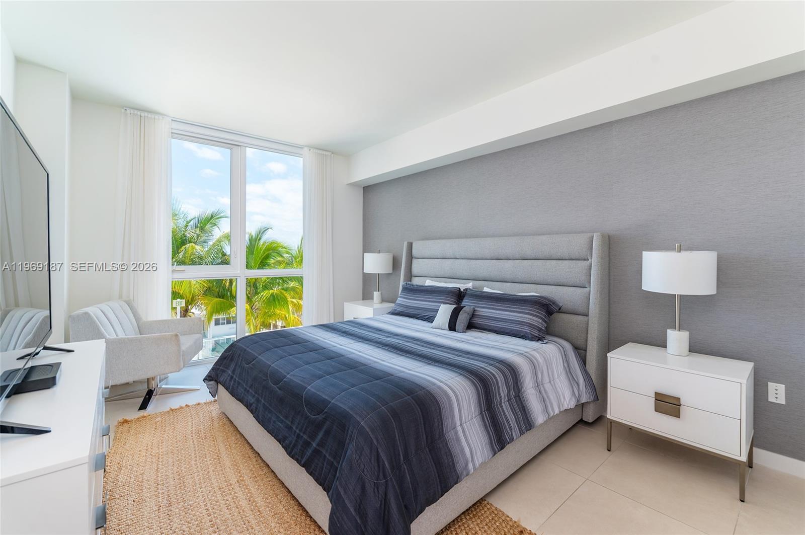 401 North Birch Road, Unit 502 Fort Lauderdale, FL 33304 - Photo 11 of 52 a bedroom with a bed and a large window