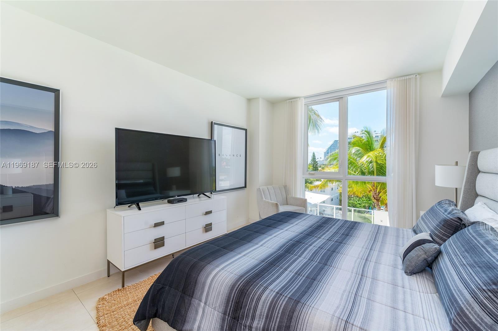 401 North Birch Road, Unit 502 Fort Lauderdale, FL 33304 - Photo 12 of 52 a bedroom with a bed and a flat screen tv