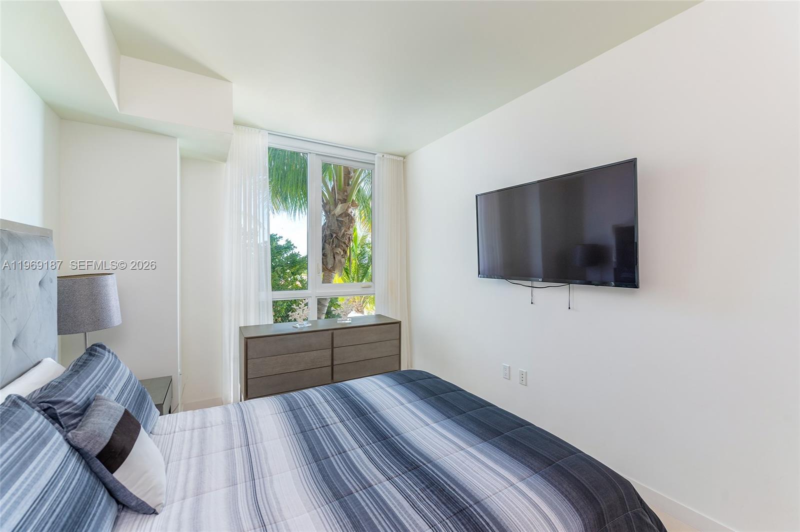 401 North Birch Road, Unit 502 Fort Lauderdale, FL 33304 - Photo 13 of 52 a bedroom with a bed and a flat screen tv