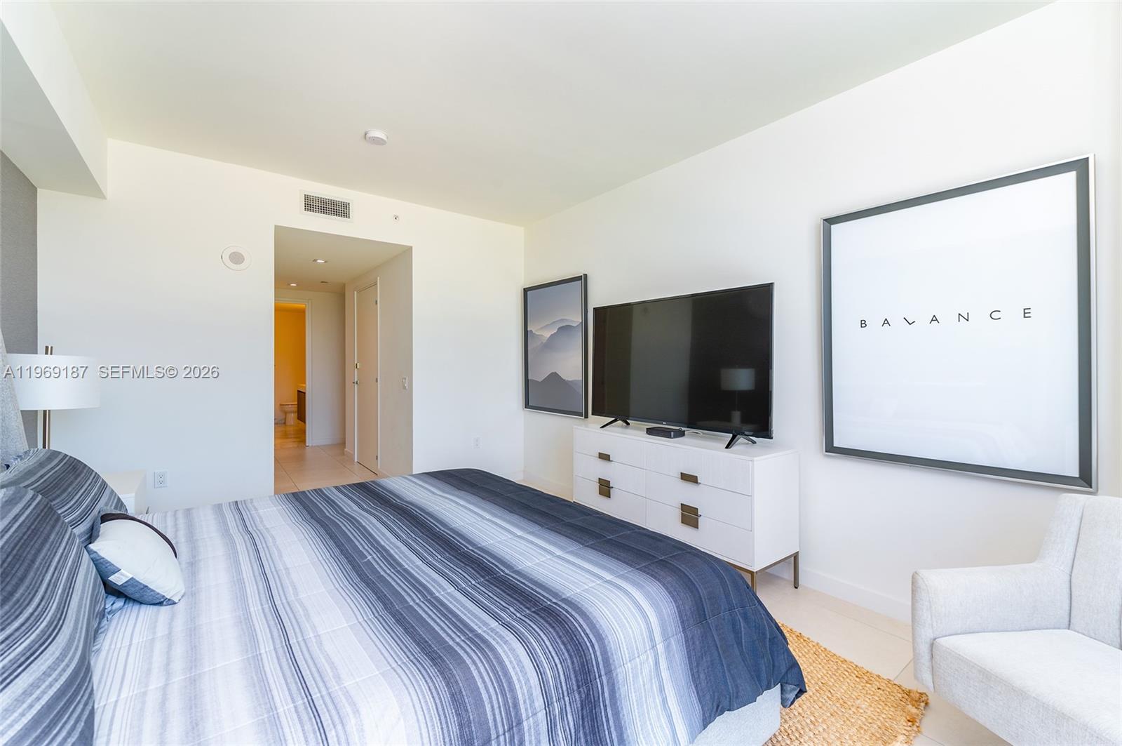 401 North Birch Road, Unit 502 Fort Lauderdale, FL 33304 - Photo 14 of 52 a bedroom with a bed and a flat screen tv