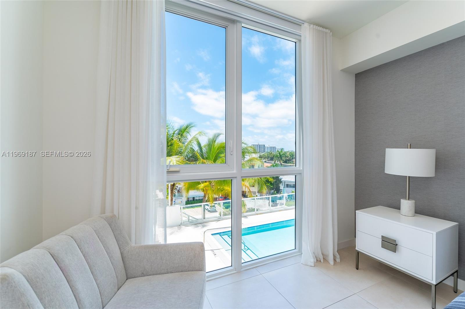 401 North Birch Road, Unit 502 Fort Lauderdale, FL 33304 - Photo 19 of 52 a living room with furniture and a floor to ceiling window