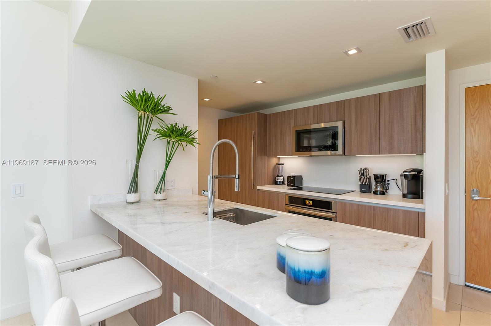401 North Birch Road, Unit 502 Fort Lauderdale, FL 33304 - Photo 4 of 52 a kitchen with a sink a stove and cabinets