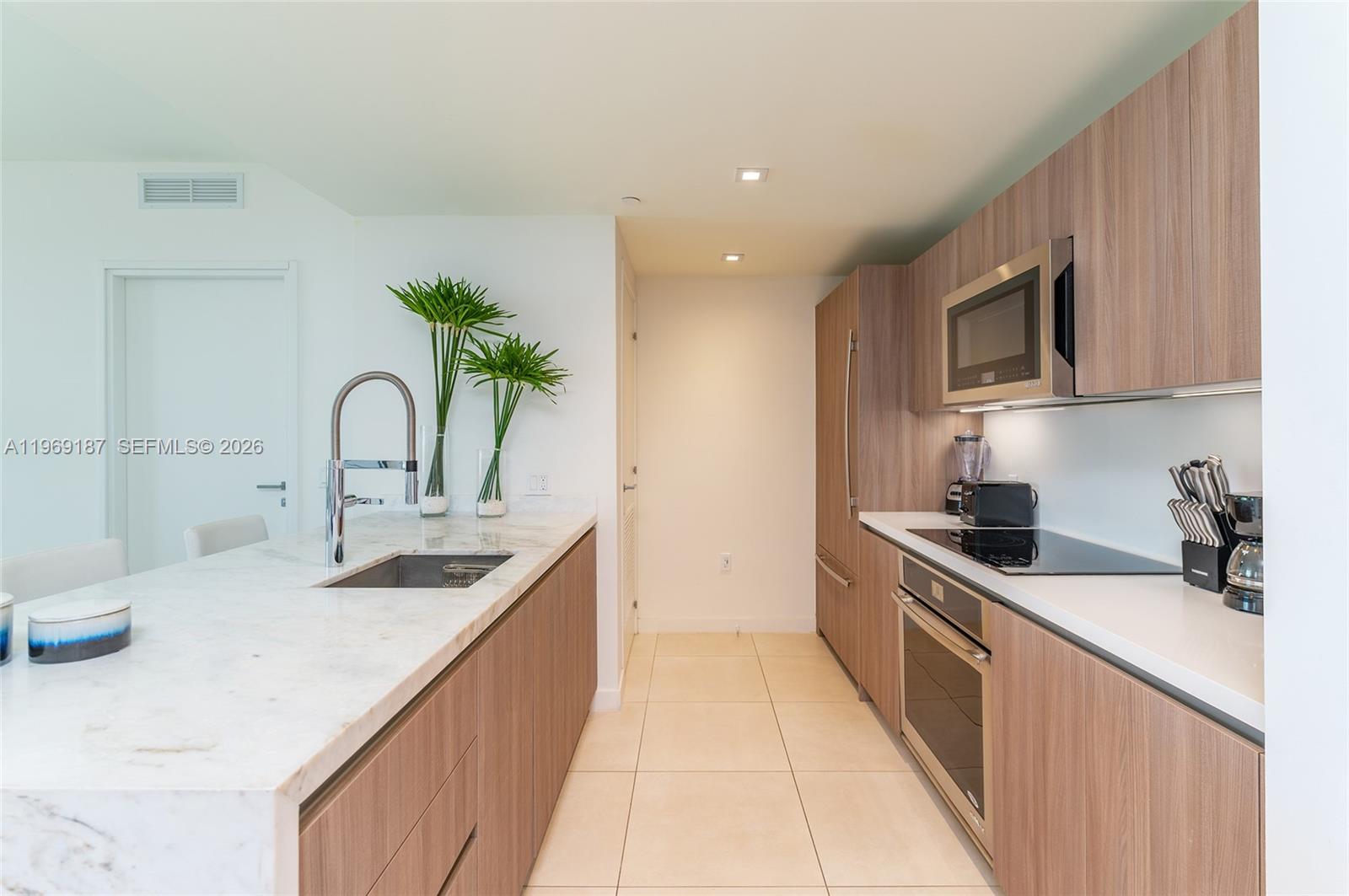 401 North Birch Road, Unit 502 Fort Lauderdale, FL 33304 - Photo 5 of 52 a kitchen with a sink and cabinets