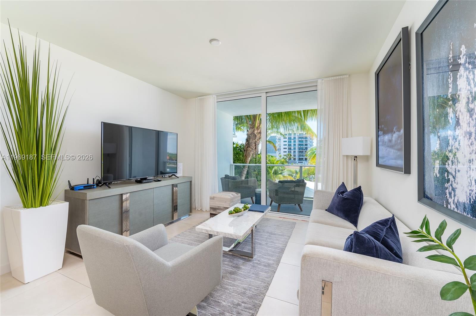 401 North Birch Road, Unit 502 Fort Lauderdale, FL 33304 - Photo 6 of 52 a living room with furniture and a large window