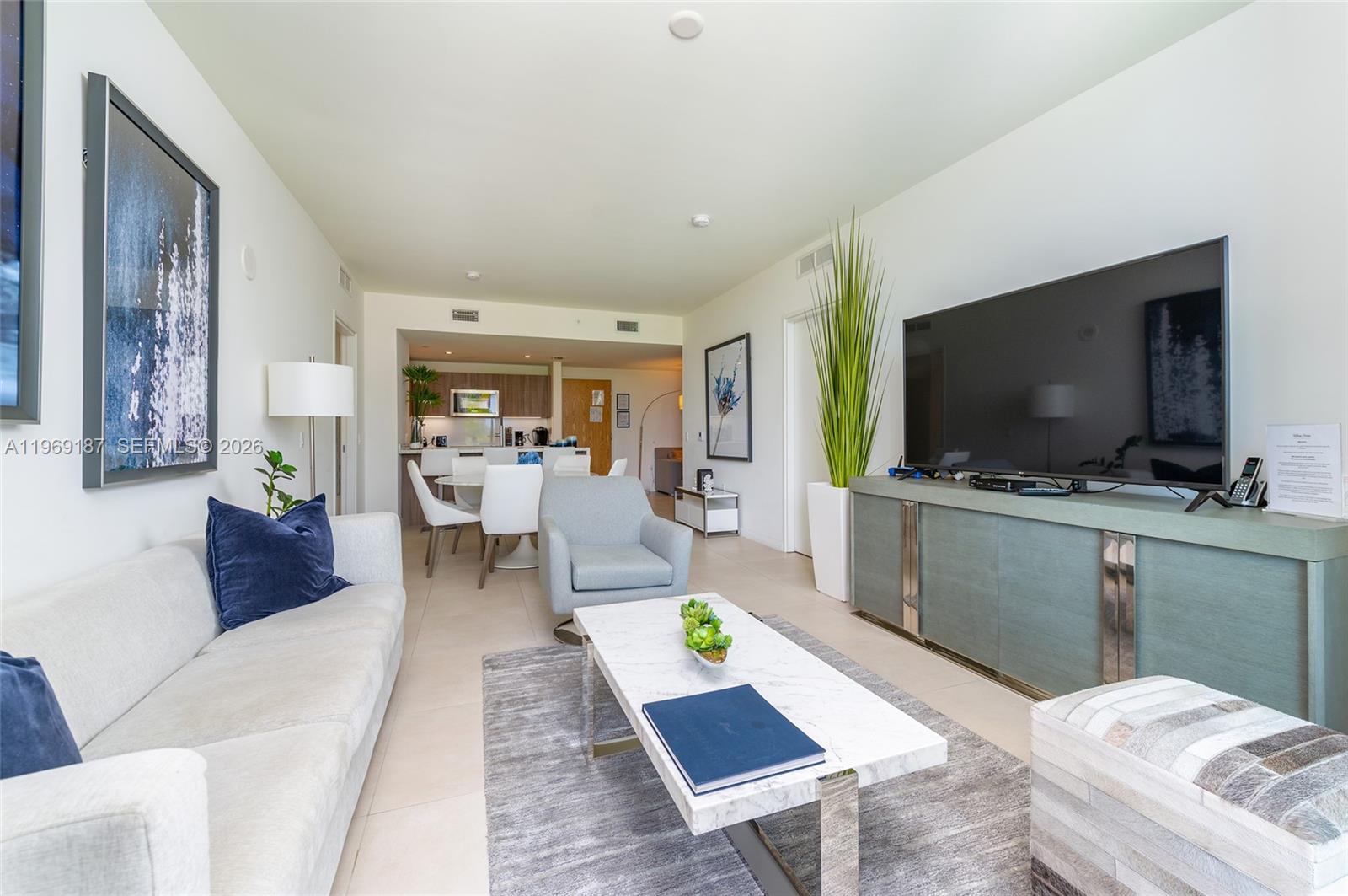 401 North Birch Road, Unit 502 Fort Lauderdale, FL 33304 - Photo 7 of 52 a living room with furniture and a flat screen tv