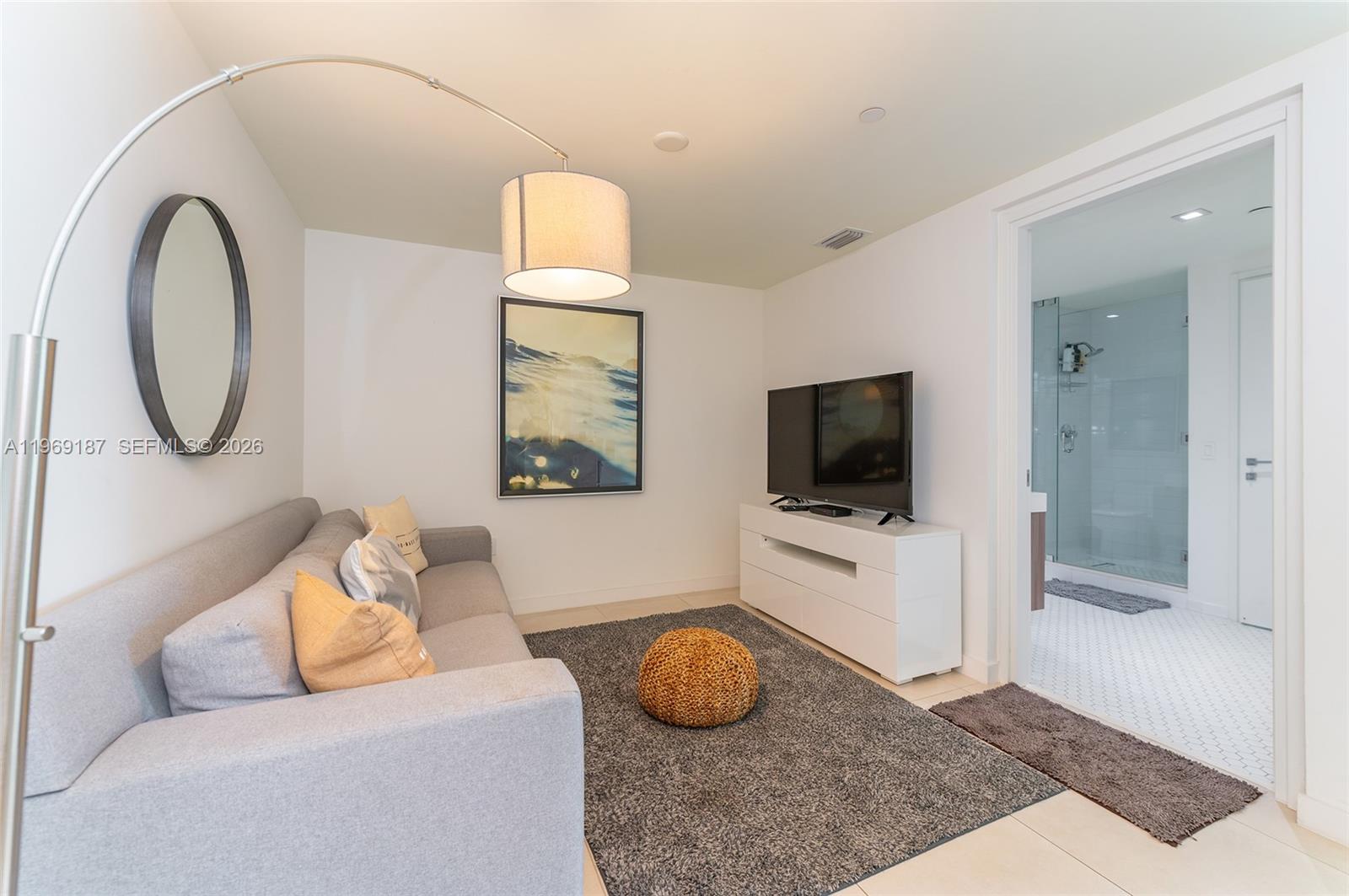 401 North Birch Road, Unit 502 Fort Lauderdale, FL 33304 - Photo 8 of 52 a living room with furniture and a flat screen tv