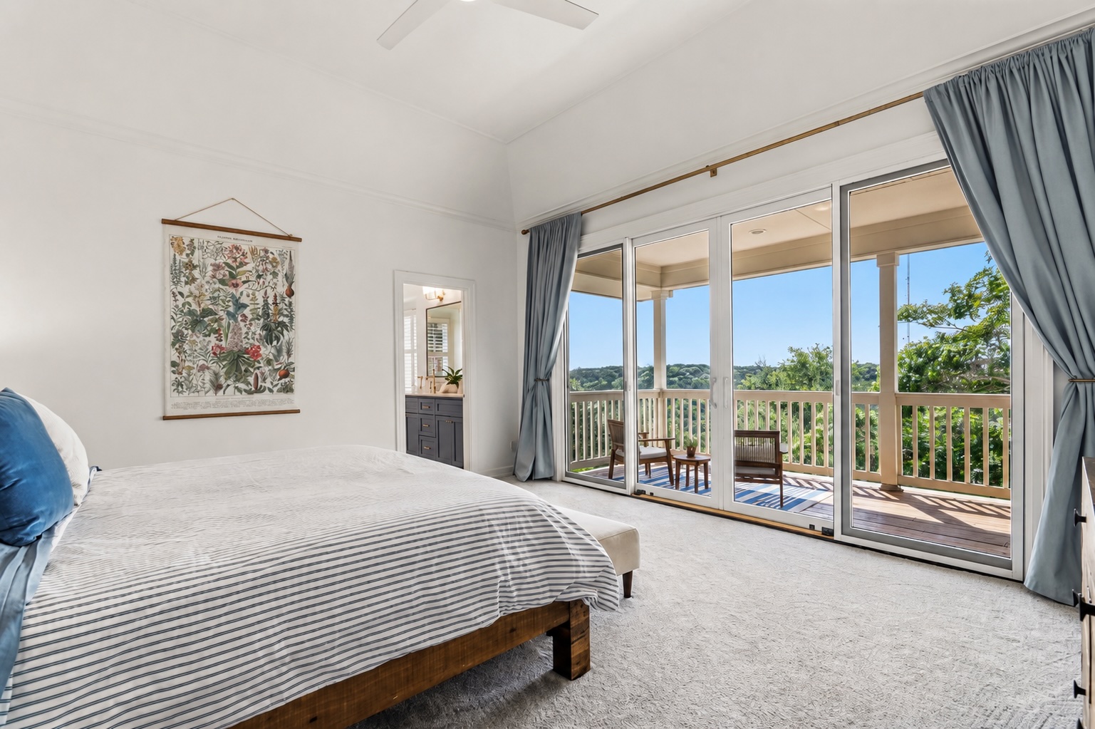 3107 Lookout Lane Austin, TX 78746 - Photo 22 of 39 Step into a primary bedroom with direct access to a private balcony, offering serene outdoor views.