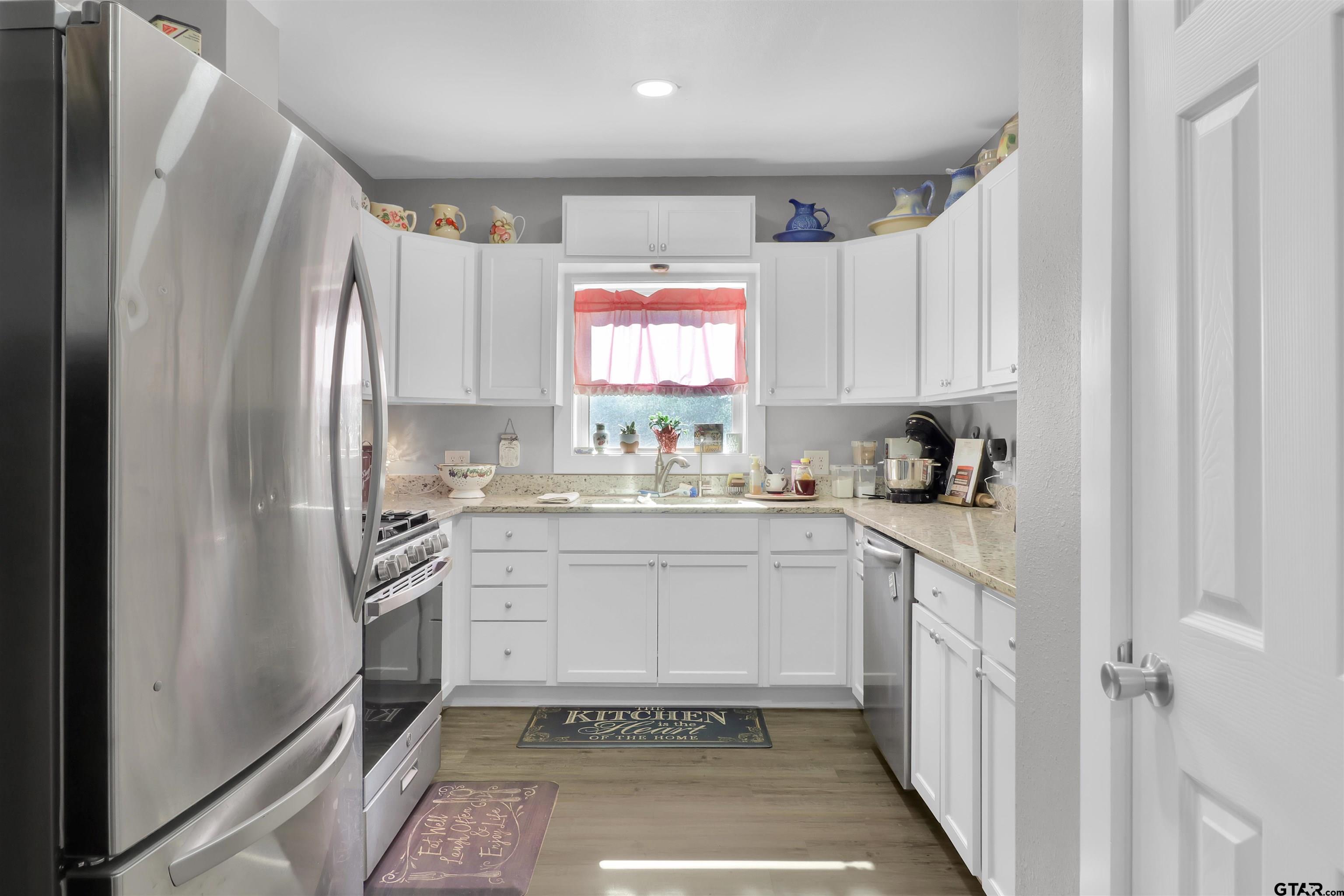 554 East San Antonio Street Alto, TX 75925 - Photo 11 of 28 a kitchen with a refrigerator sink and cabinets