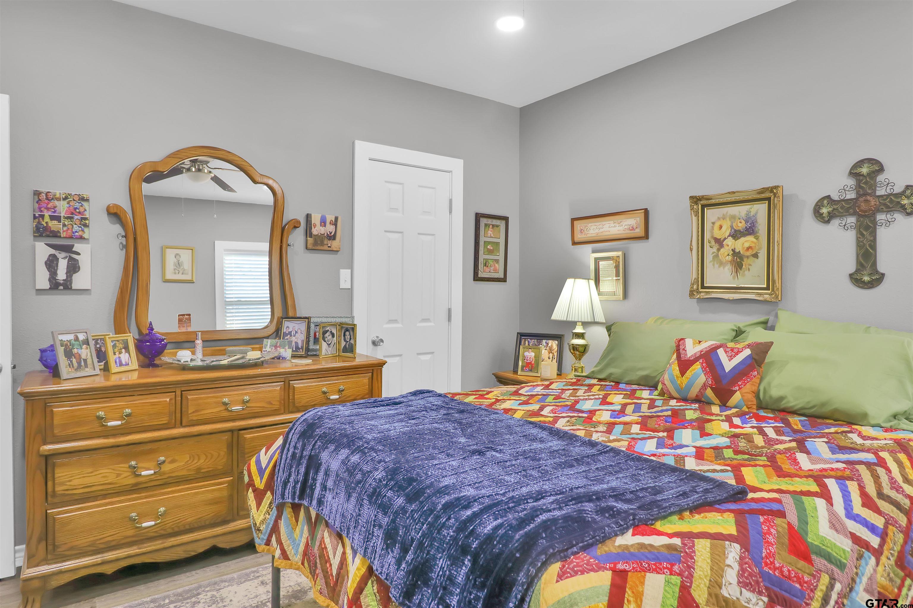 554 East San Antonio Street Alto, TX 75925 - Photo 16 of 28 a bedroom with a bed and a dresser in it