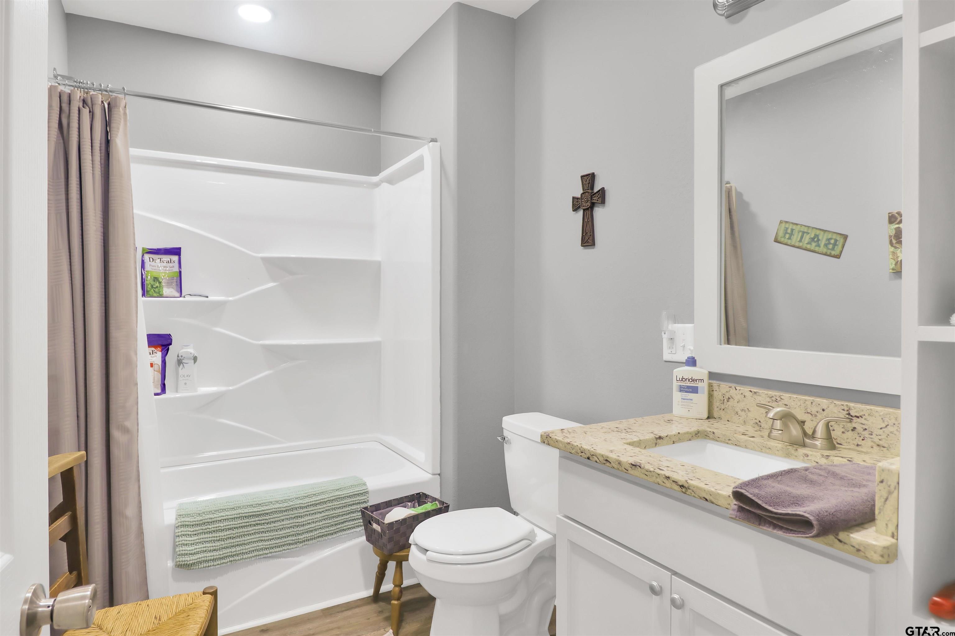 554 East San Antonio Street Alto, TX 75925 - Photo 17 of 28 a bathroom with a granite countertop sink toilet and shower