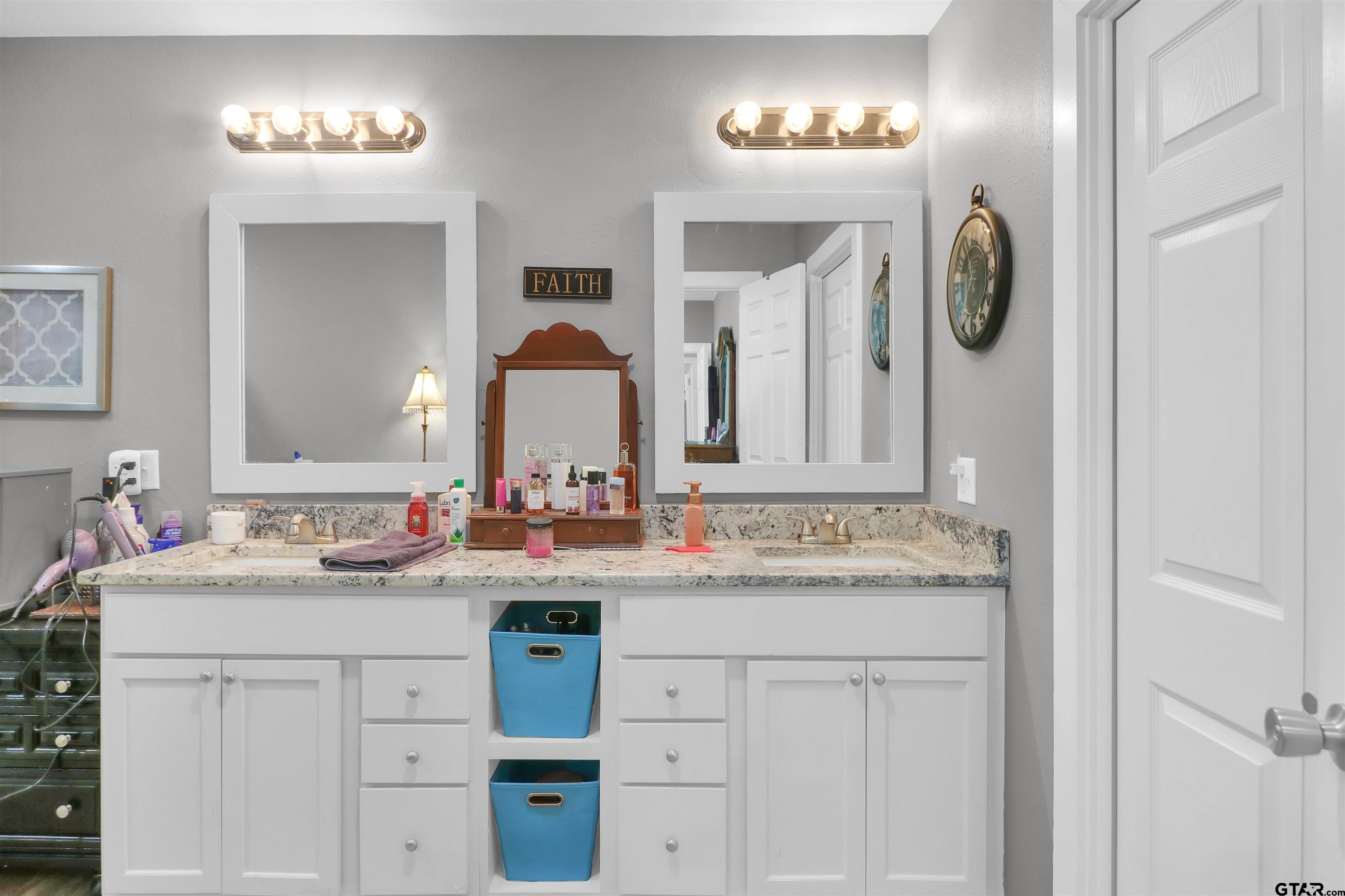 554 East San Antonio Street Alto, TX 75925 - Photo 22 of 28 a bathroom with a double vanity sink and a mirror