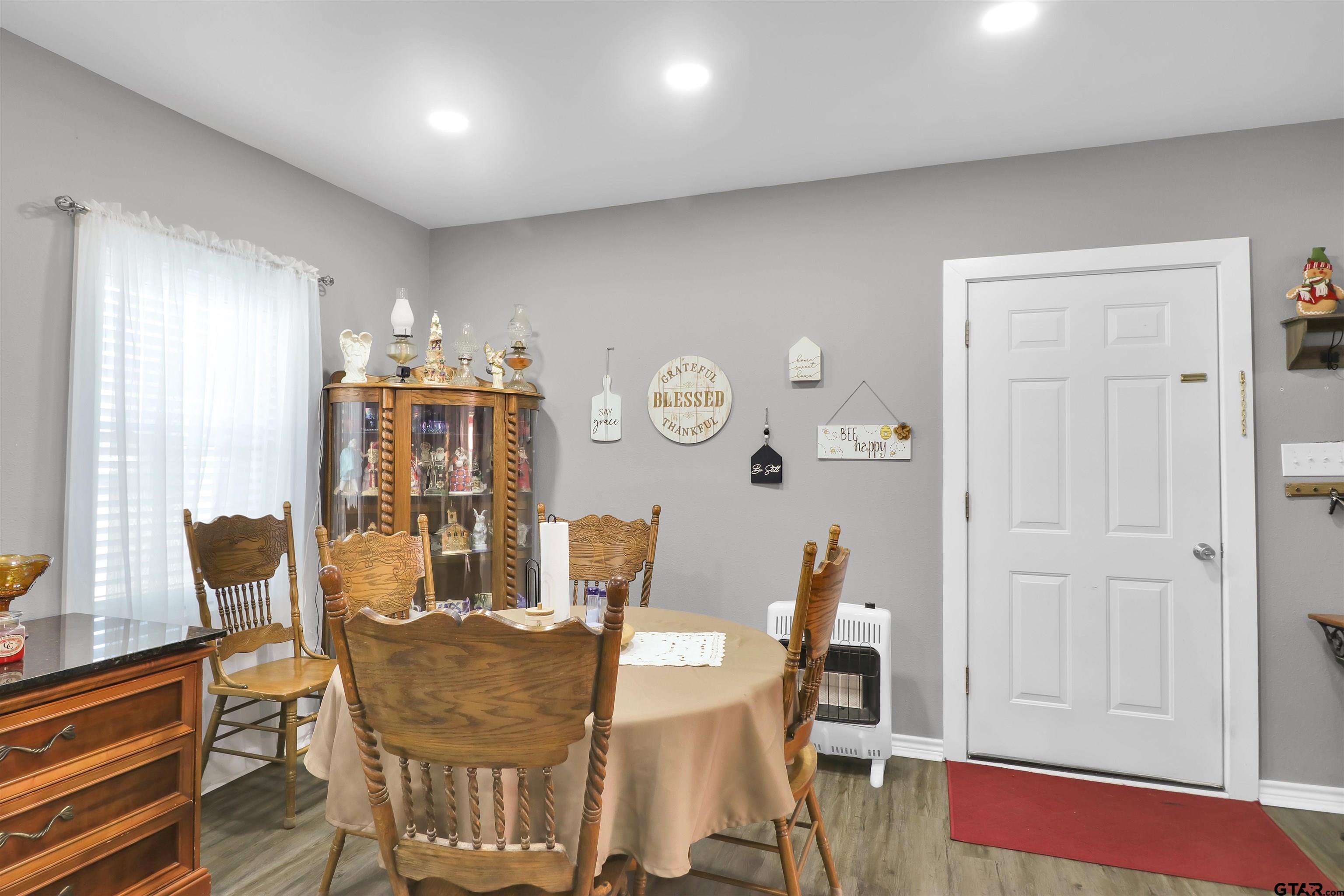 554 East San Antonio Street Alto, TX 75925 - Photo 9 of 28 a view of a dining room with furniture and wooden floor