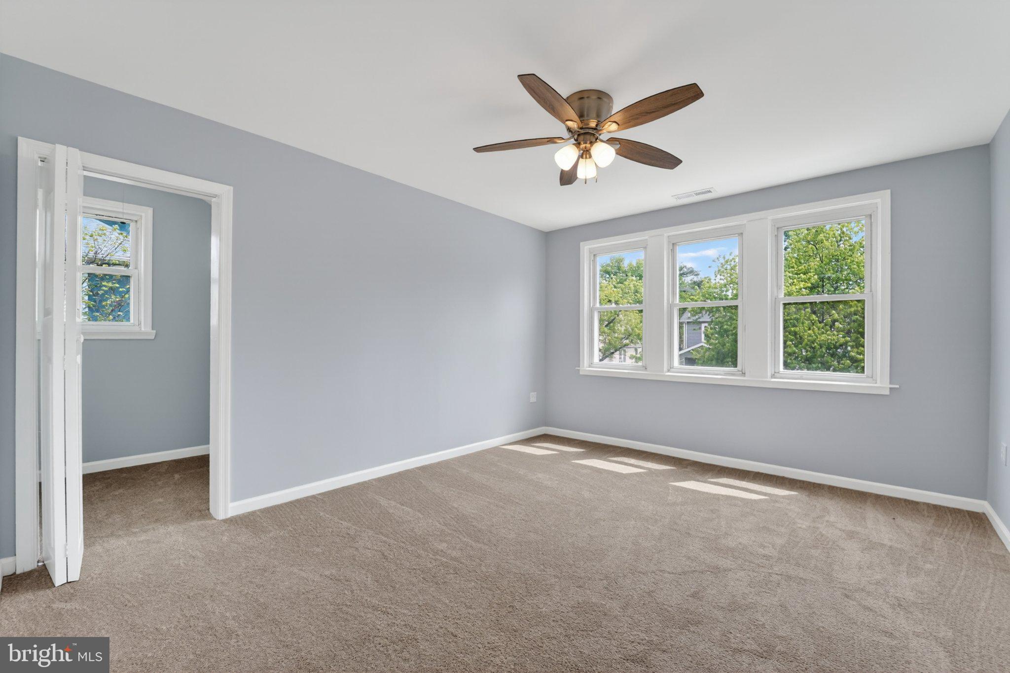 5312 Catalpha Road Baltimore, MD 21214 - Photo 47 of 59 a view of a big room with windows and ceiling fan