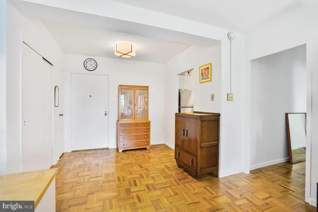 a view of a kitchen with furniture and an empty room