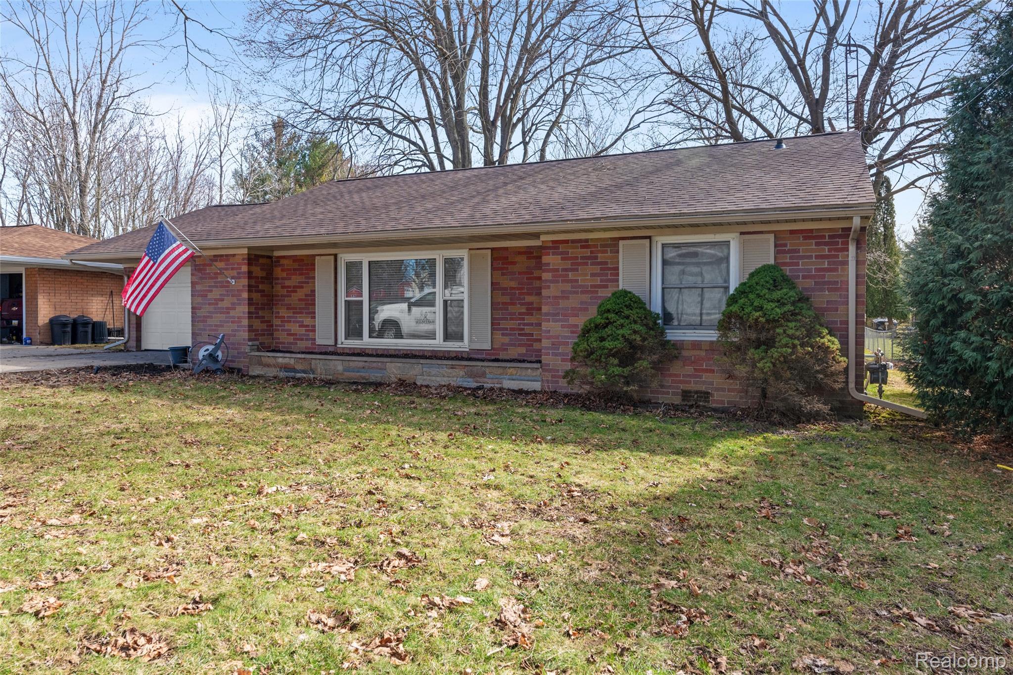 8150 Davison Road Davison, MI 48423 - Photo 1 of 25 Single story home with brick siding, an attached garage, a front yard, and concrete driveway