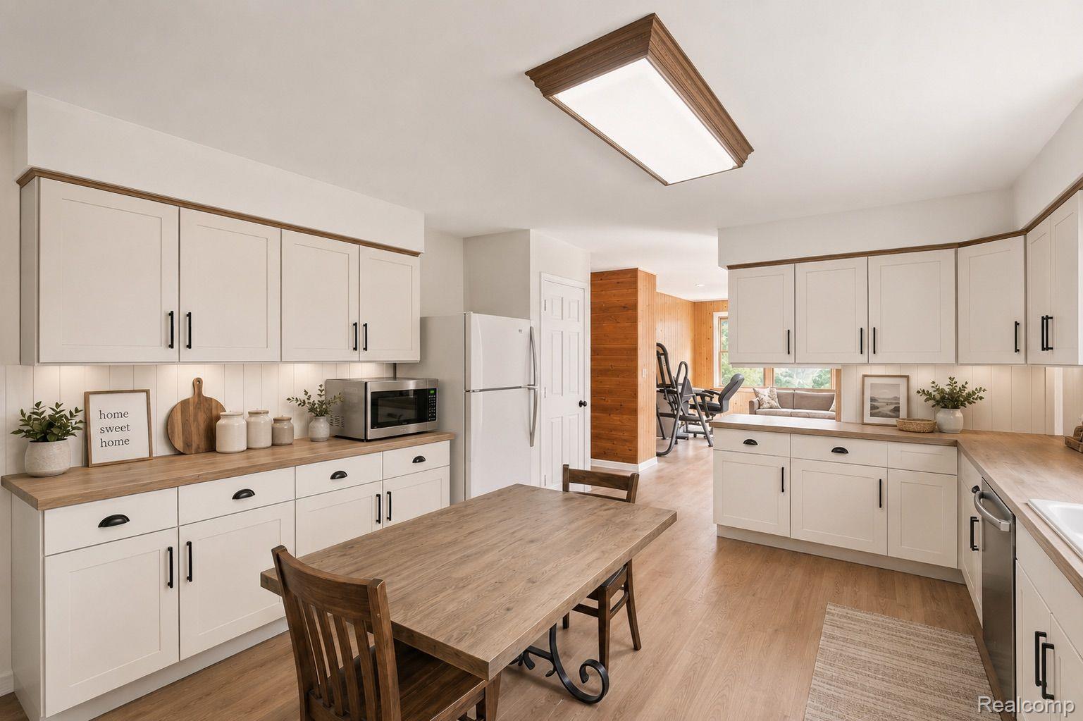 76565 McFadden Road Armada, MI 48005 - Photo 17 of 95 White shaker-style cabinetry with dark hardware, wood-finish countertops, wood-finish flooring, and a recessed ceiling light fixture